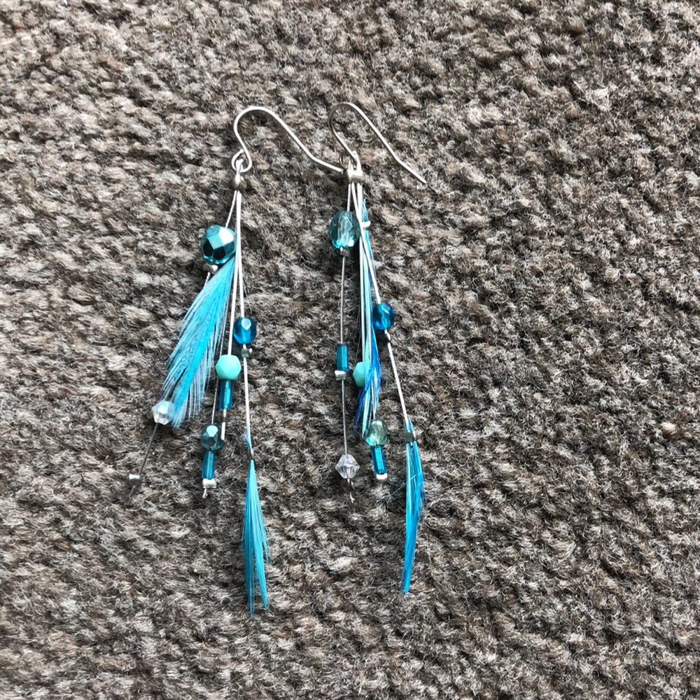 Blue earrings with feathers.